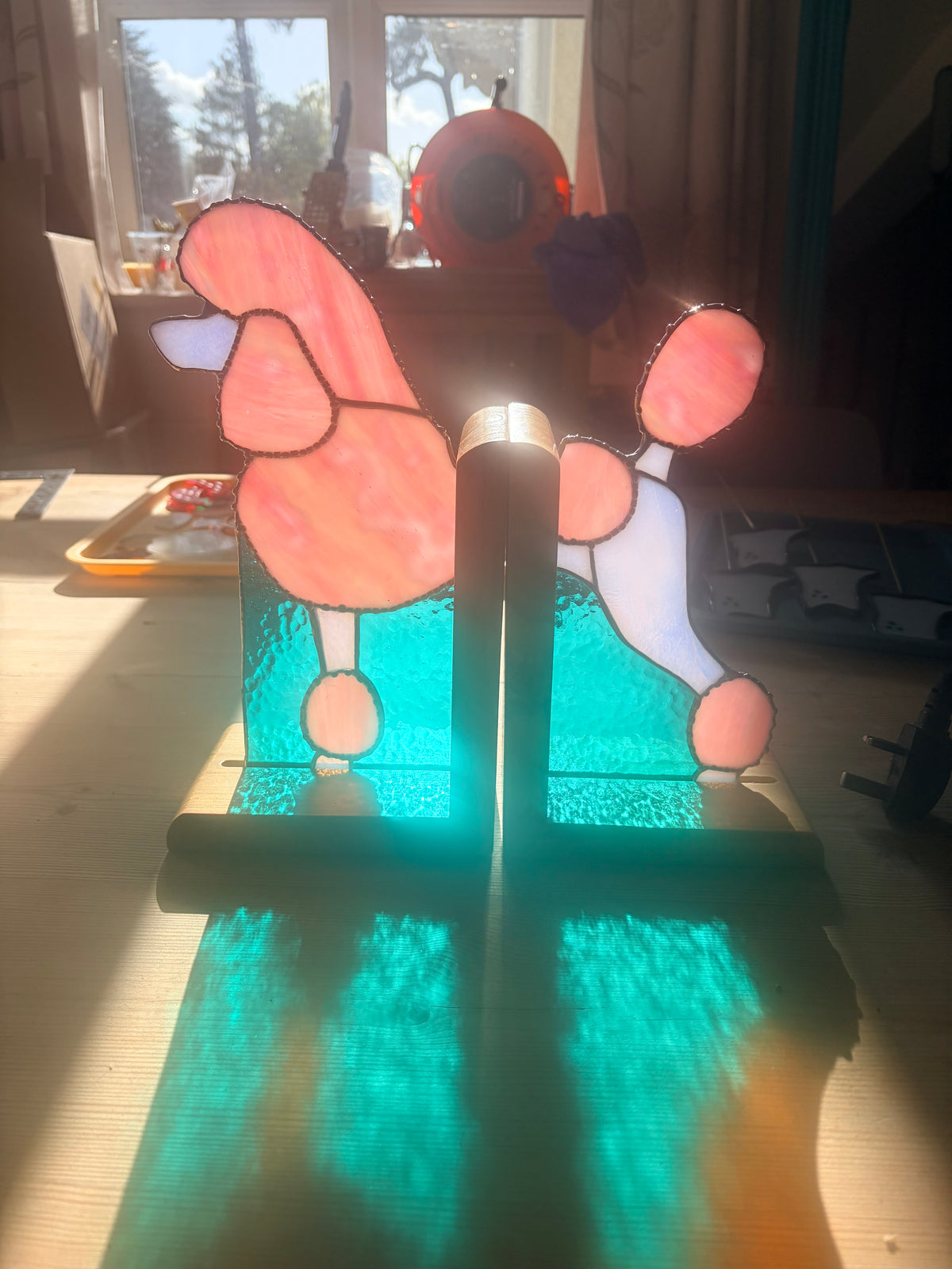 The bookends in the artists workshop with light going through them, backlit showing how glowy the glass is