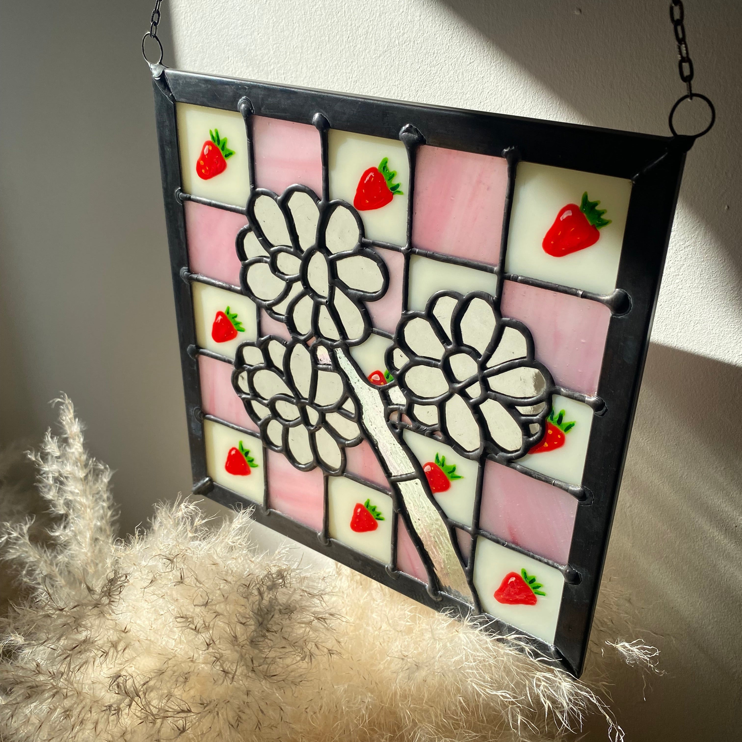 Stained glass panel with fungal design and strawberries on a light background