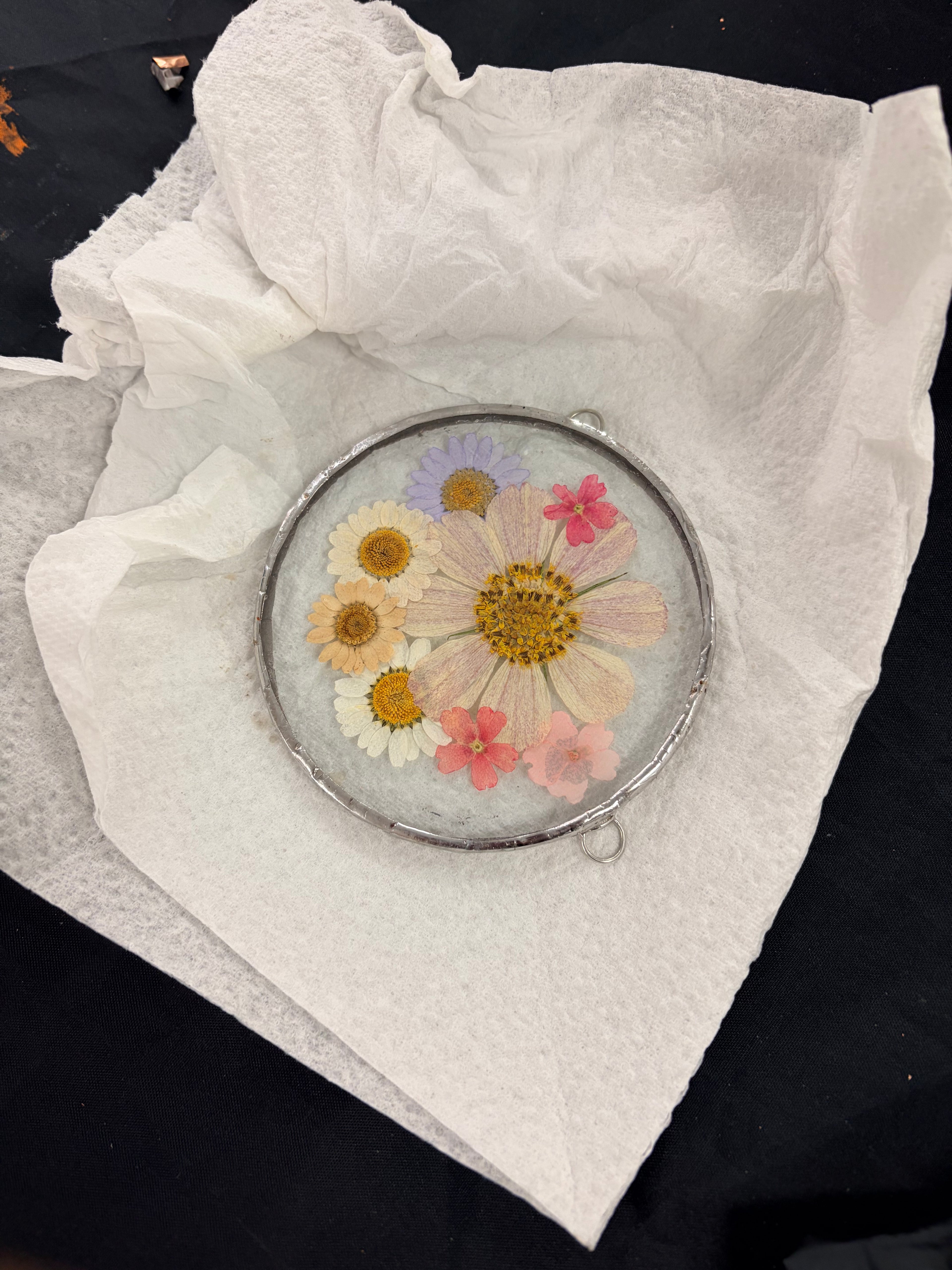 Compact mirror with pressed flowers on a white cloth