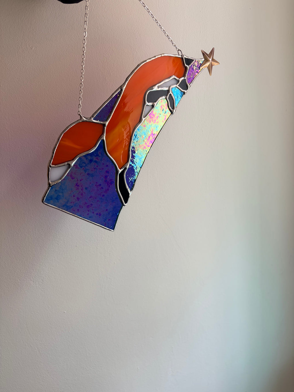 Stained glass red fox design, jumping along starlight. iridescent glass shining.