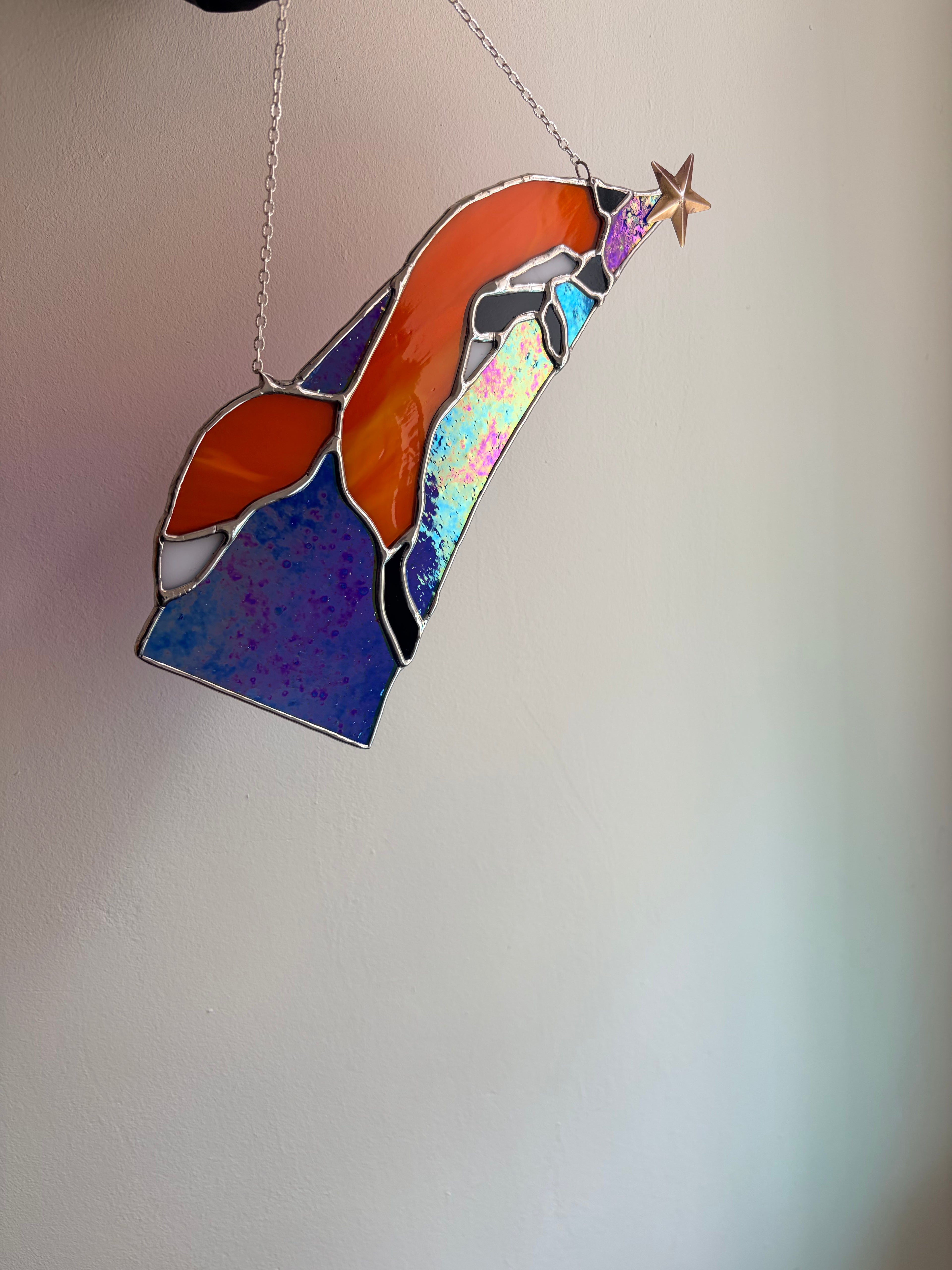 Stained glass red fox design, jumping along starlight. iridescent glass shining.