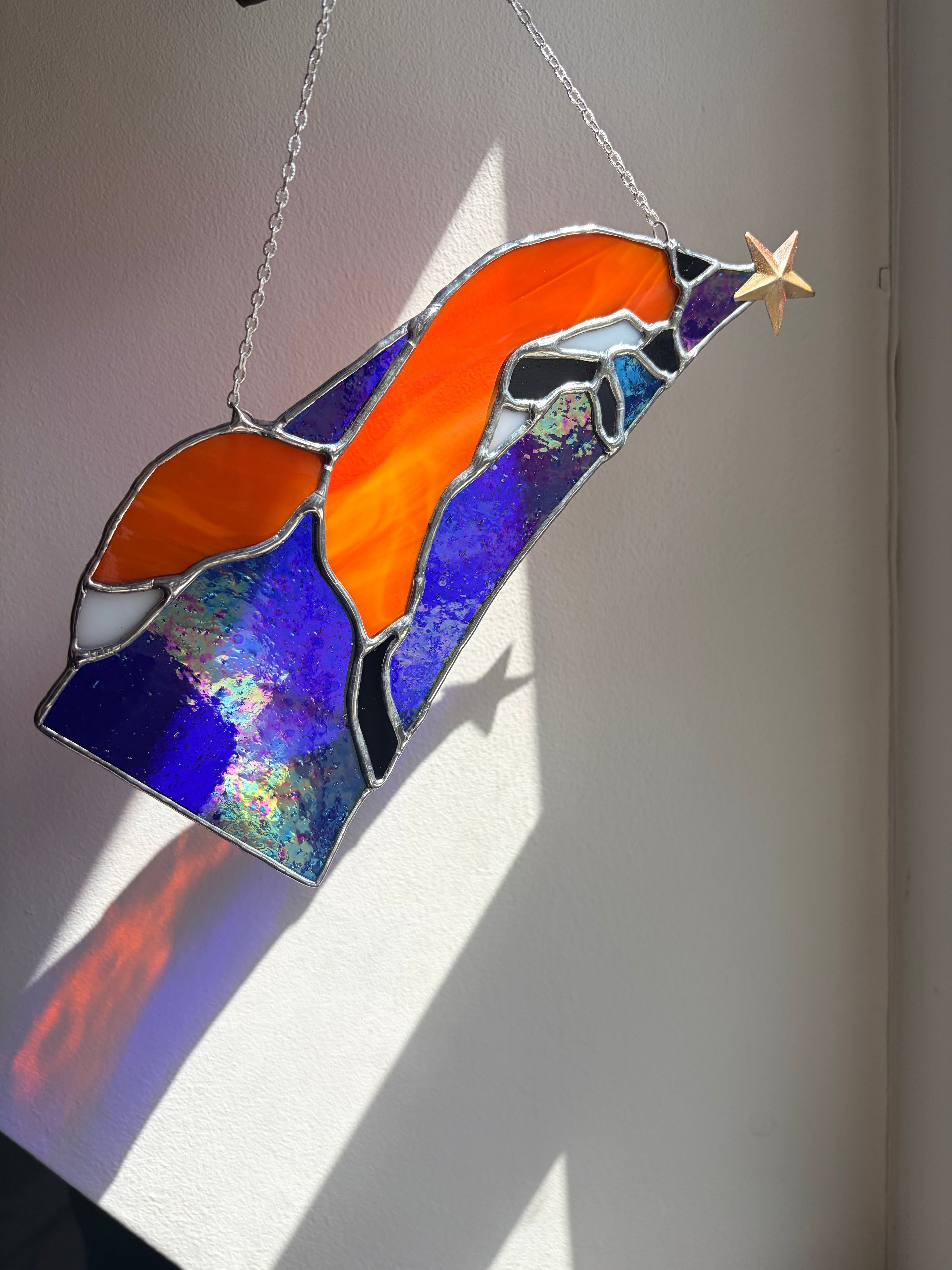 Stained glass red fox jumping along starlight