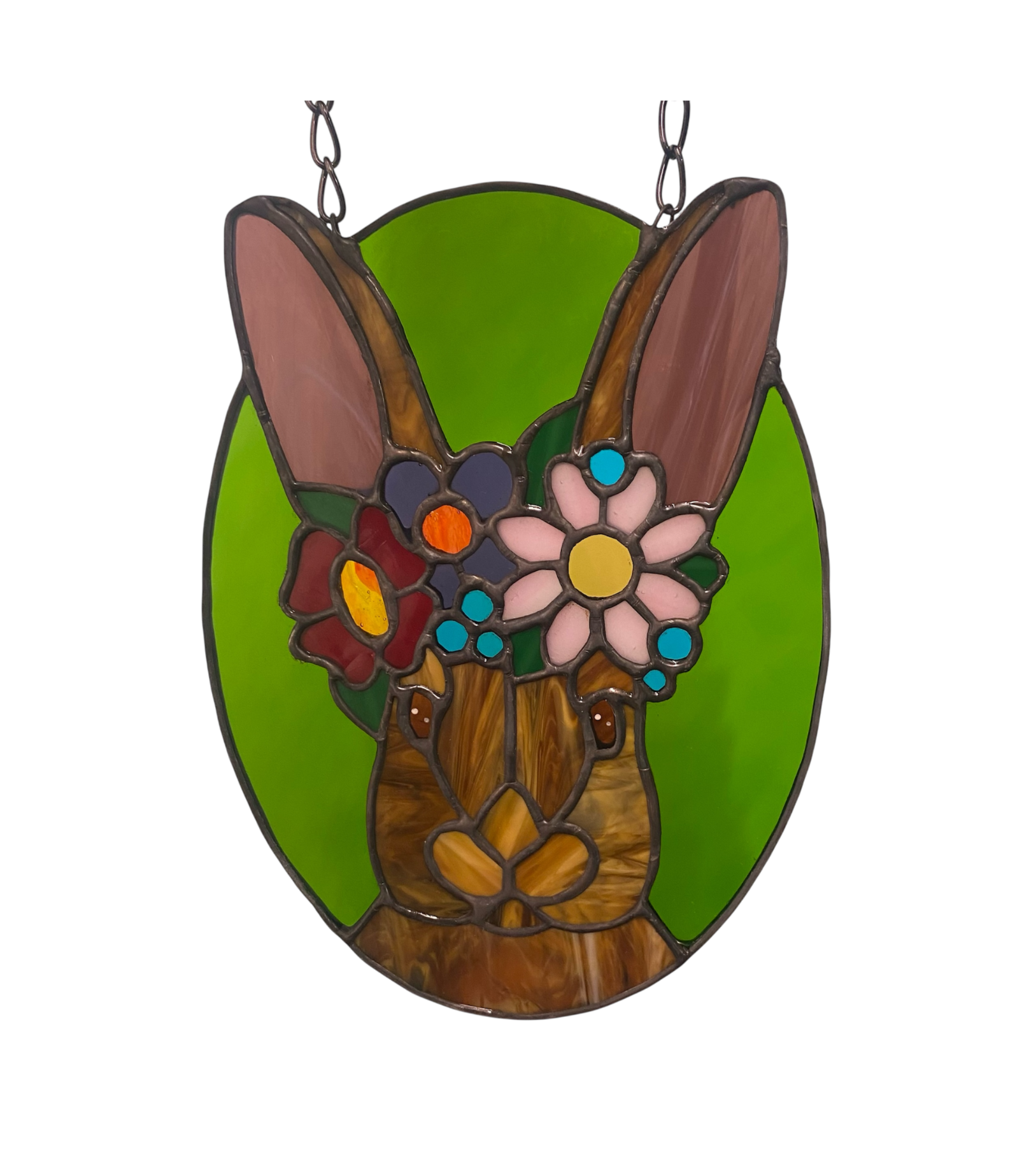 Stained glass window hanging of a rabbit with flowers on a green background