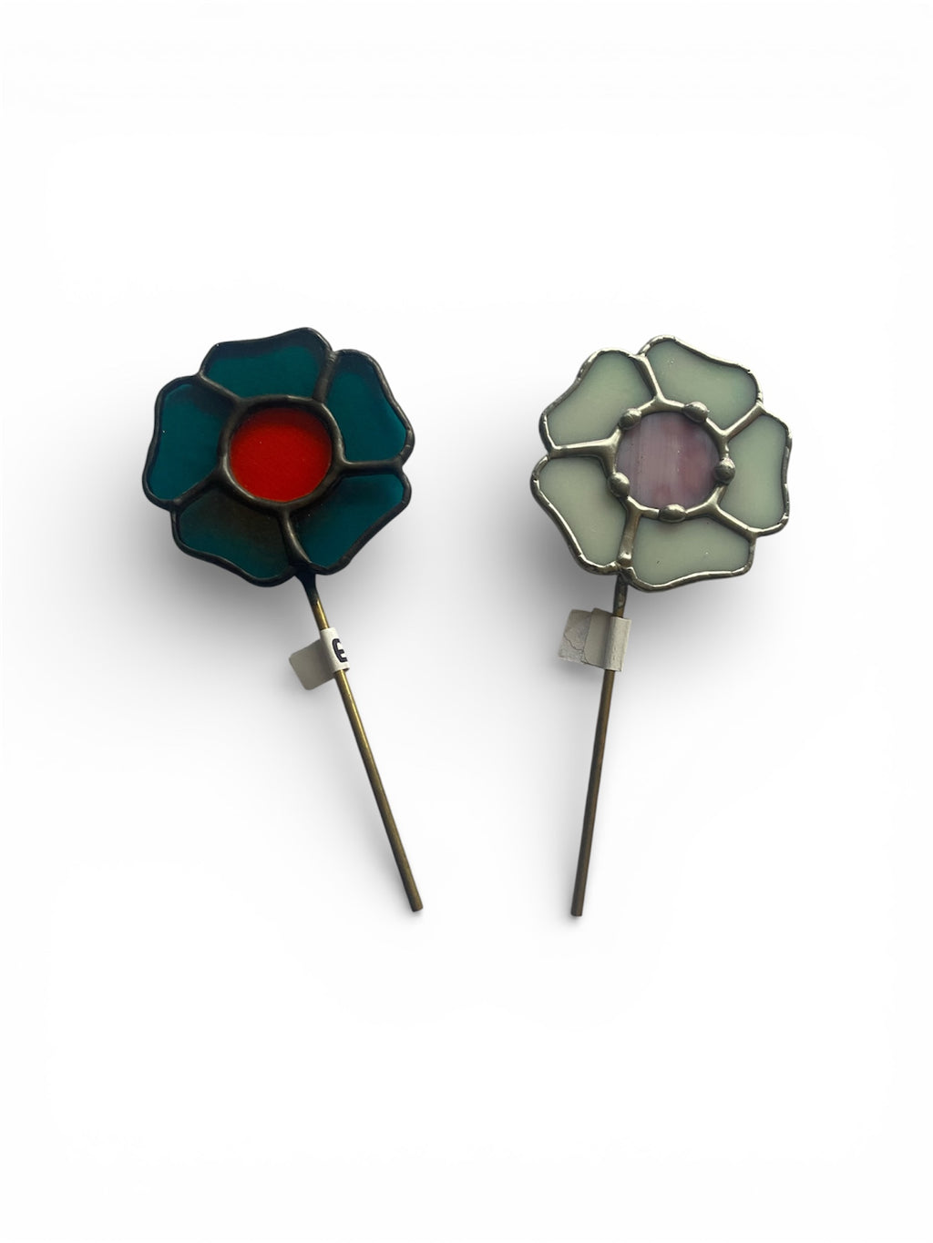 Two floral stained glass plant stakes with colored centers on a white background