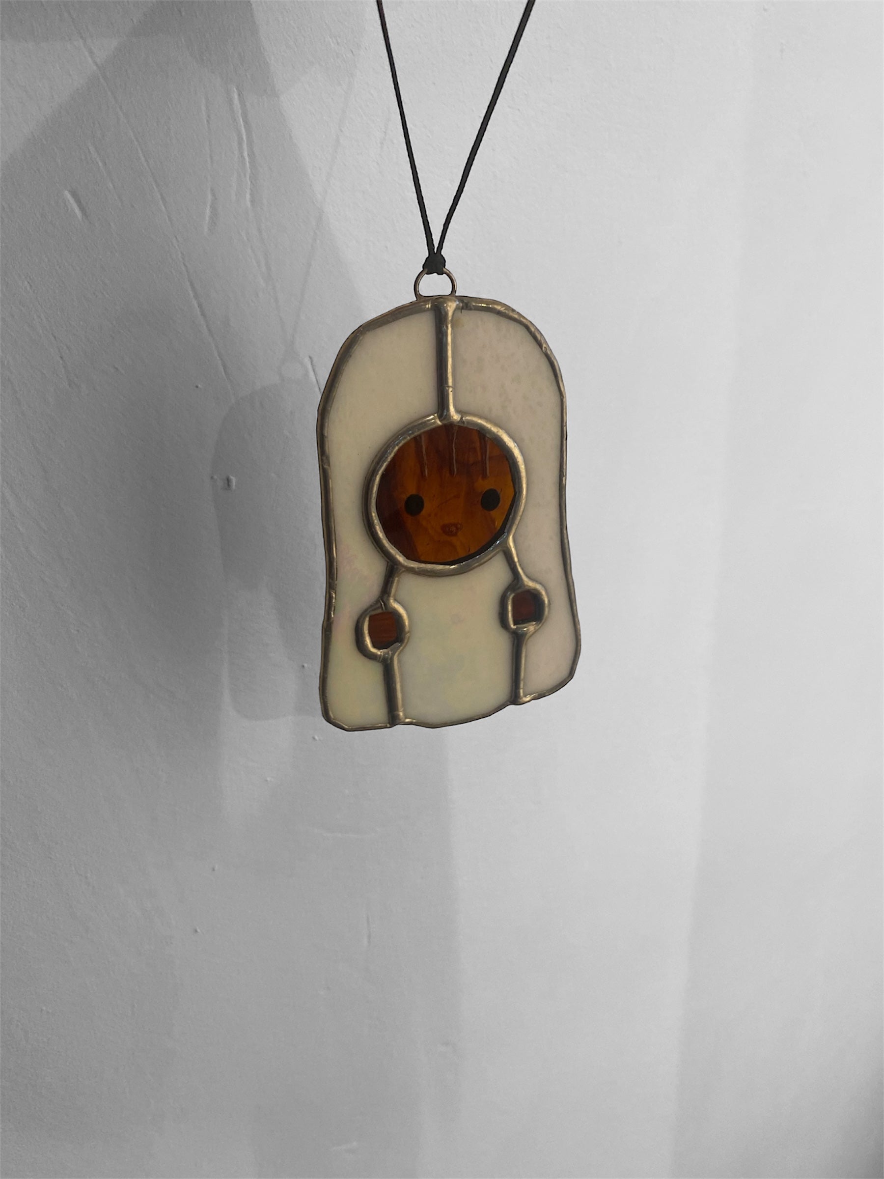Kawaii-style squirrel character with a ghost costume stained glass ornament on a gray background