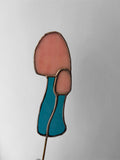 Decorative item with pink and blue design on a white background