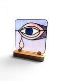 Decorative lamp with eye design on a white background