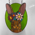 Stained glass window hanging of a rabbit with a flower crown on a white background